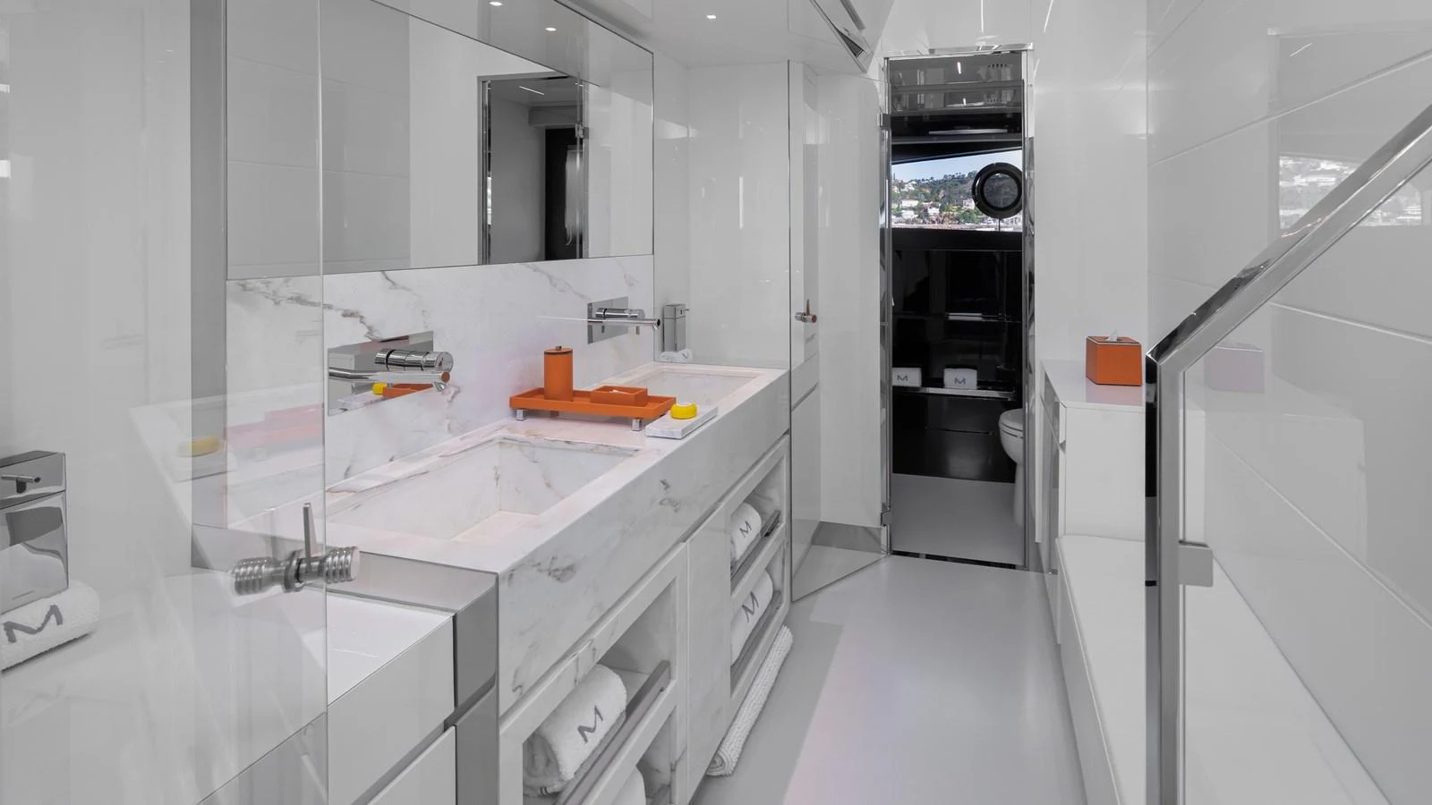 A luxurious yacht bathroom featuring a sleek, modern design with marble accents and ample storage. aboard M Yacht for Sale