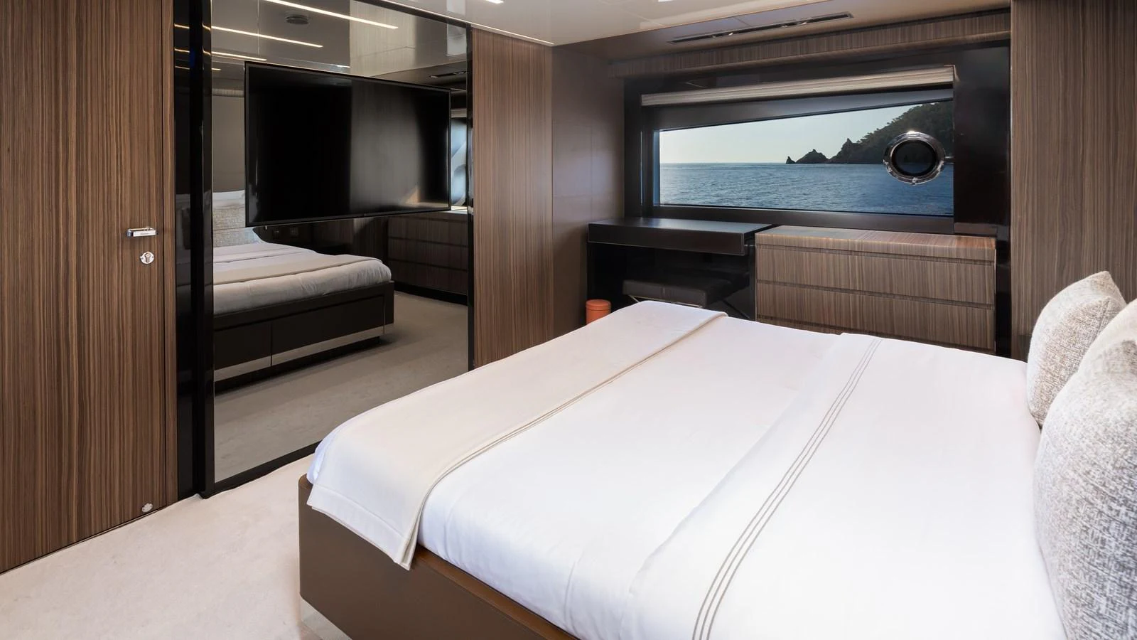 A luxurious stateroom featuring a large bed, modern furnishings, and a scenic ocean view. aboard M Yacht for Sale