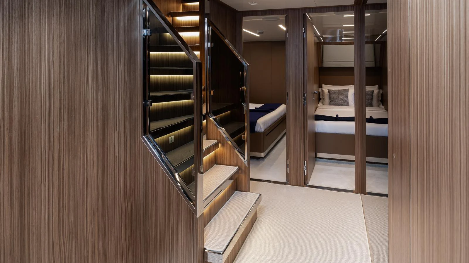 The image showcases a luxurious interior with a staircase leading to well-appointed cabins. aboard M Yacht for Sale