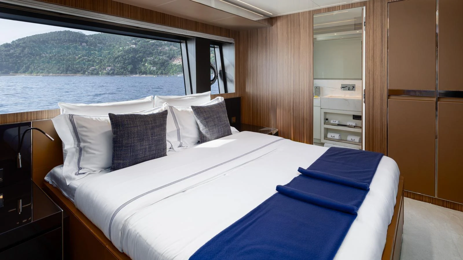 The stateroom offers a luxurious and serene retreat with a large bed and scenic views through the window. aboard M Yacht for Sale