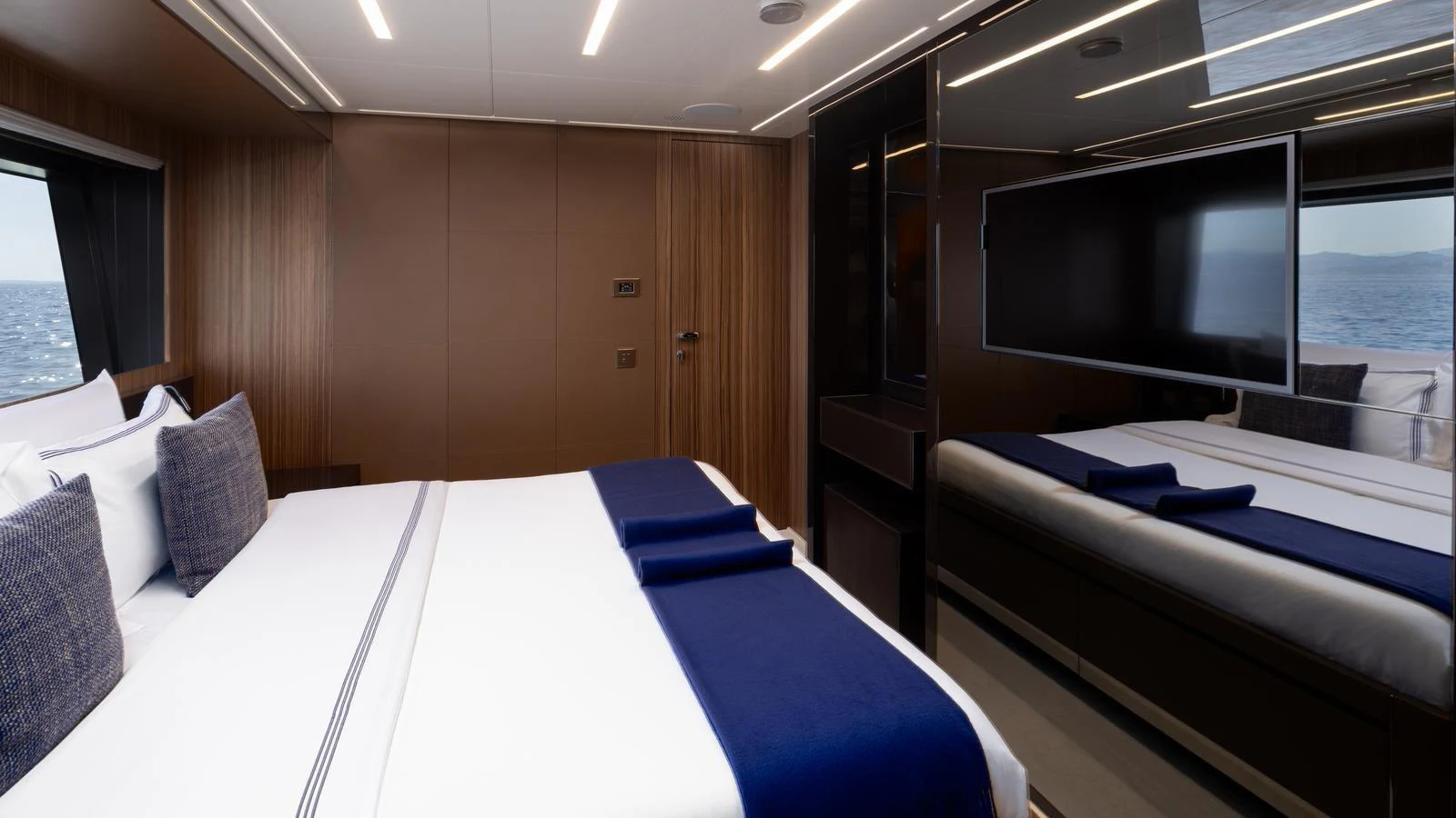 A luxurious stateroom featuring a large bed with elegant linens and modern decor. aboard M Yacht for Sale