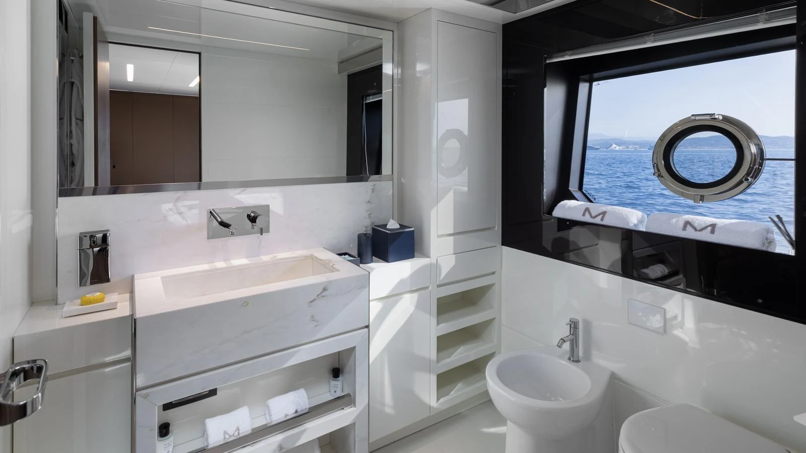 A sleek and modern bathroom with a large window offering a stunning sea view. aboard M Yacht for Sale