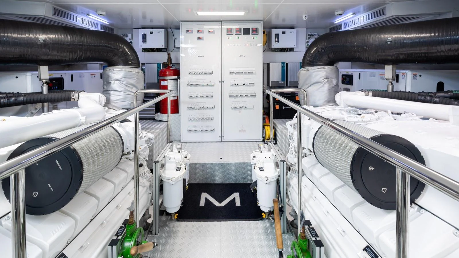 The engine room is meticulously organized, showcasing advanced machinery and pristine maintenance. aboard M Yacht for Sale