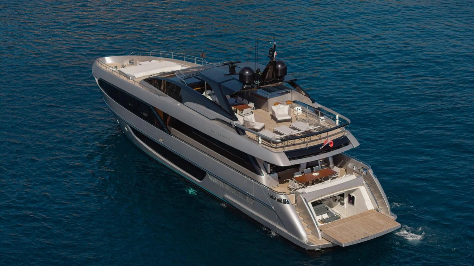 A sleek and modern yacht cruising on calm blue waters, showcasing its elegant design and spacious deck areas. aboard M Yacht for Sale