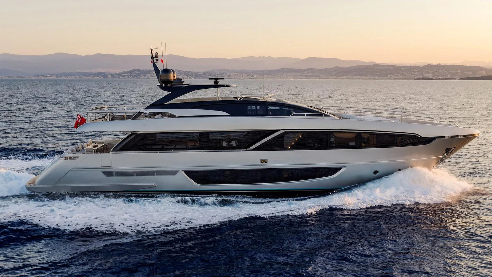 A sleek and modern yacht cruises gracefully on the open sea at sunset. aboard M Yacht for Sale