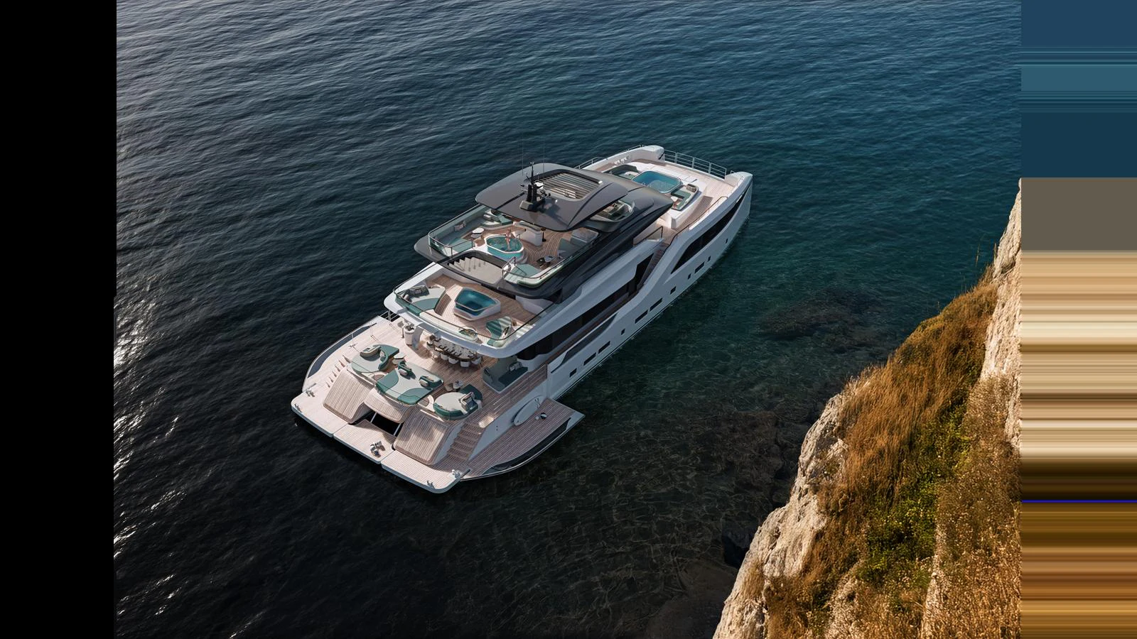 A luxurious yacht is anchored near a rocky coastline, showcasing its multiple decks and elegant design. aboard GEMINI Yacht for Sale