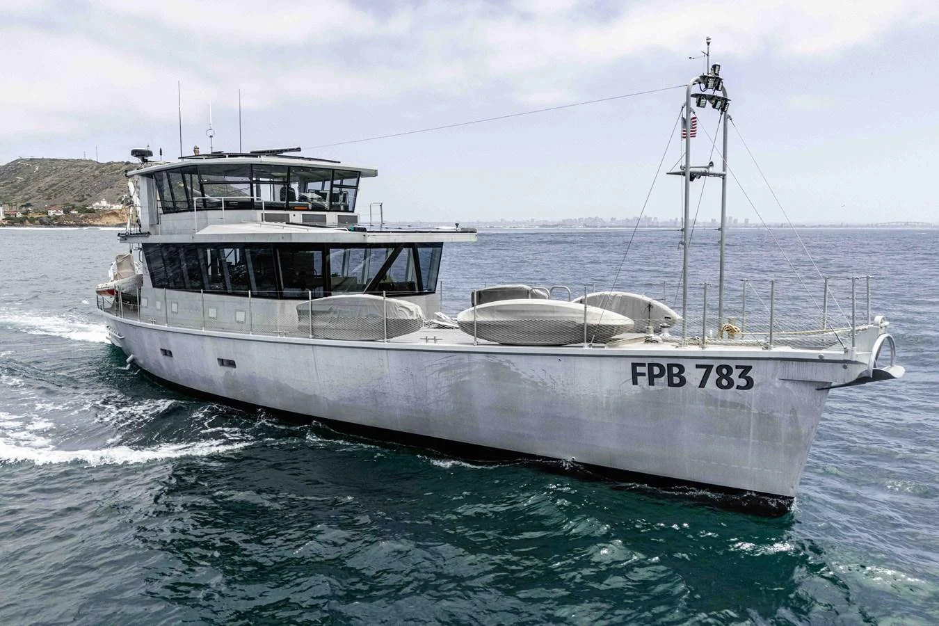 A sleek and modern yacht glides gracefully on the water, showcasing its robust design and spacious deck. aboard UGLY BETTY Yacht for Sale