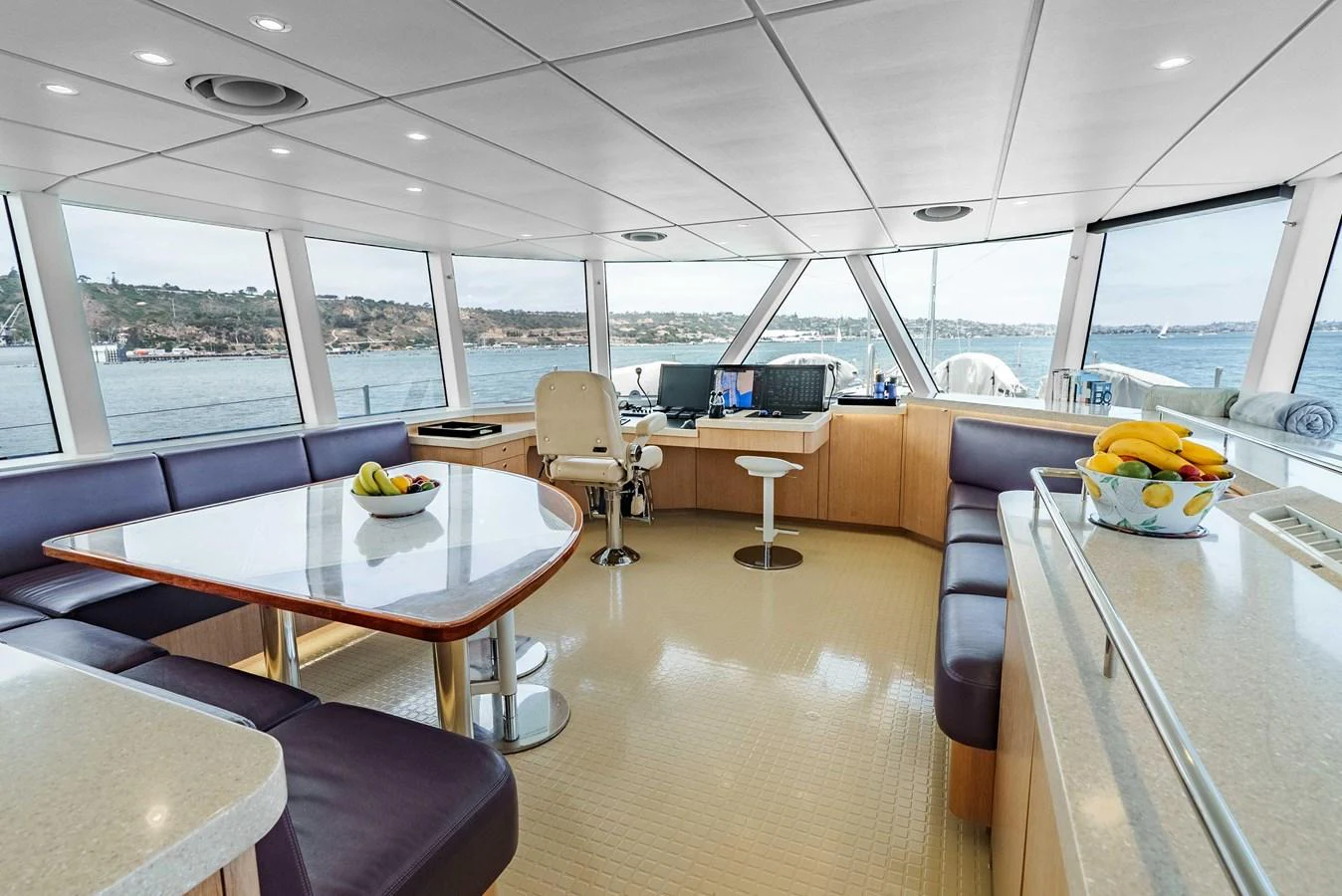 The yacht's helm area features a spacious and modern design with panoramic windows offering stunning views. aboard UGLY BETTY Yacht for Sale