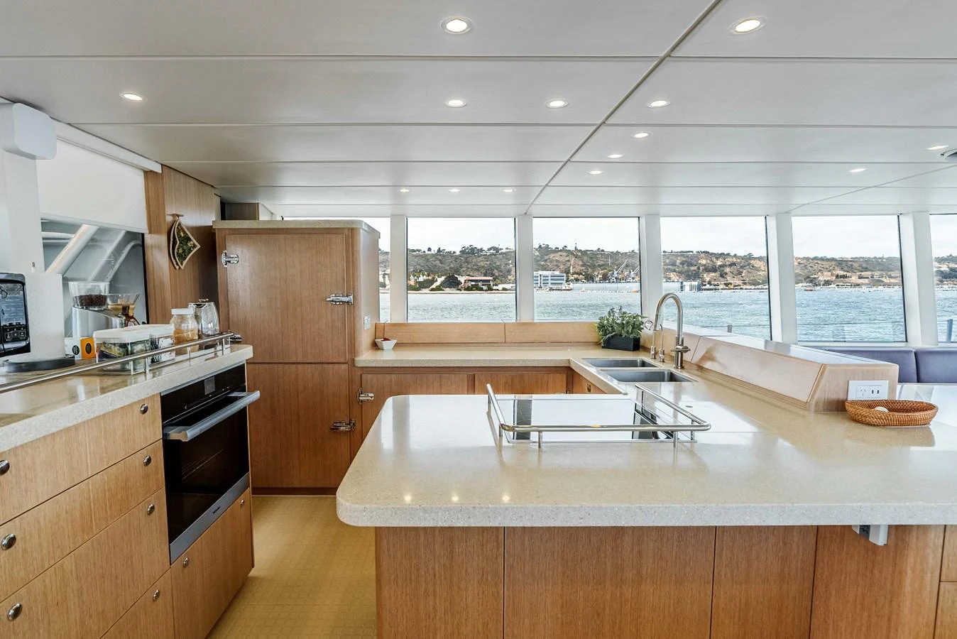 The yacht's galley features modern appliances and ample counter space with a scenic view through large windows. aboard UGLY BETTY Yacht for Sale