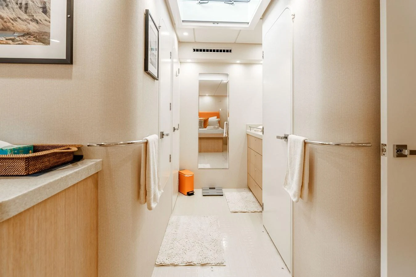 A well-lit hallway with modern decor and practical amenities. aboard UGLY BETTY Yacht for Sale
