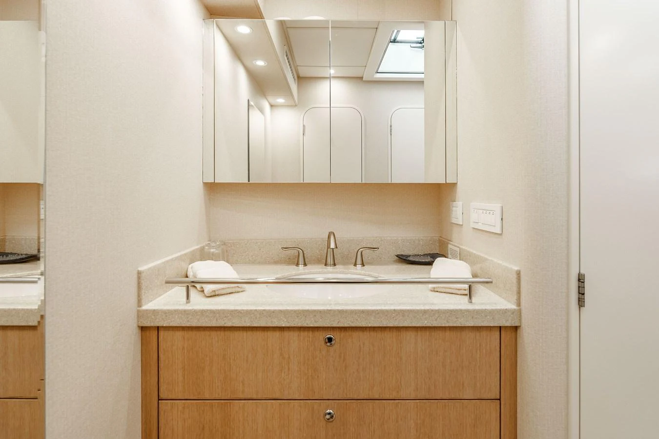 The yacht's bathroom features a sleek vanity with ample storage and a modern mirror. aboard UGLY BETTY Yacht for Sale