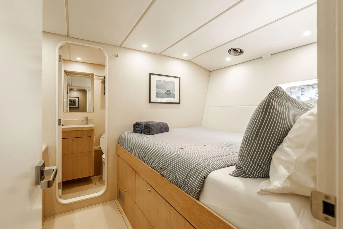 A cozy stateroom with a comfortable bed and an ensuite bathroom. aboard UGLY BETTY Yacht for Sale