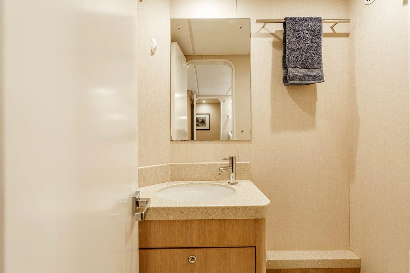 The yacht's bathroom features a sleek vanity with a modern sink and a large mirror. aboard UGLY BETTY Yacht for Sale