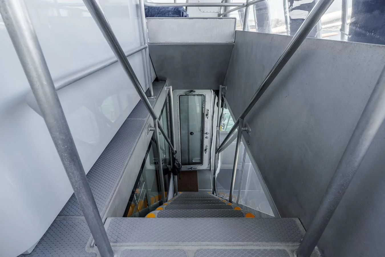 A sleek and modern staircase leading down to the lower deck of the yacht. aboard UGLY BETTY Yacht for Sale