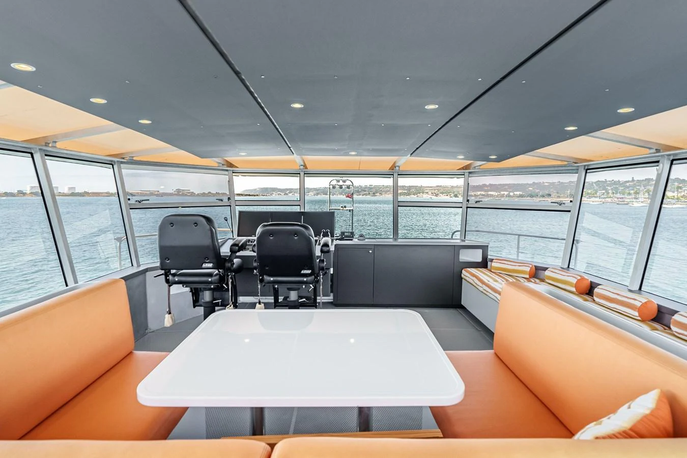 The helm area features modern seating and expansive windows offering panoramic views. aboard UGLY BETTY Yacht for Sale