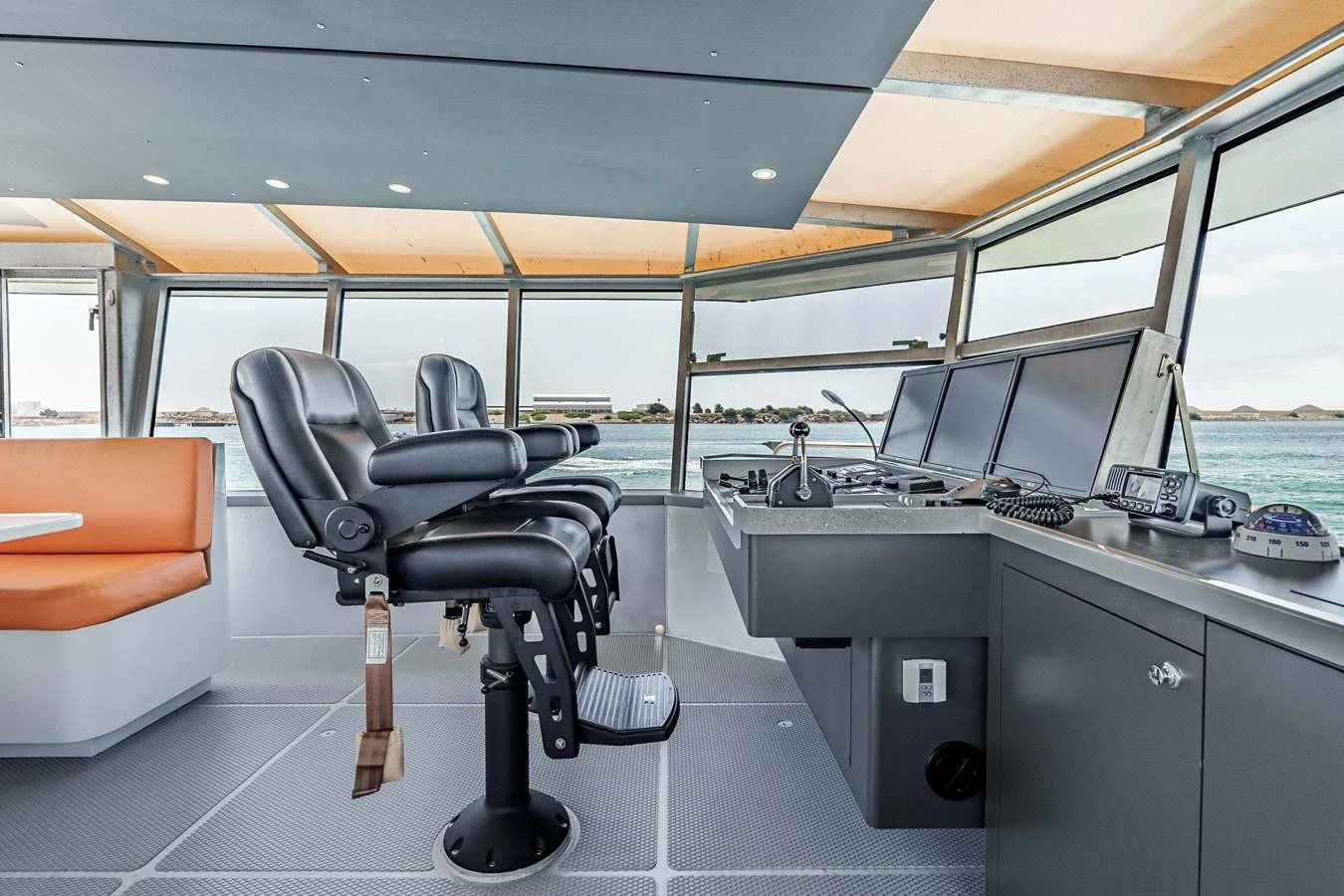 The helm station features modern navigation equipment and comfortable seating with panoramic views. aboard UGLY BETTY Yacht for Sale