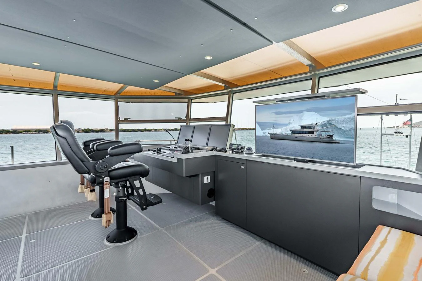 The helm station features modern navigation equipment and comfortable seating with panoramic views. aboard UGLY BETTY Yacht for Sale