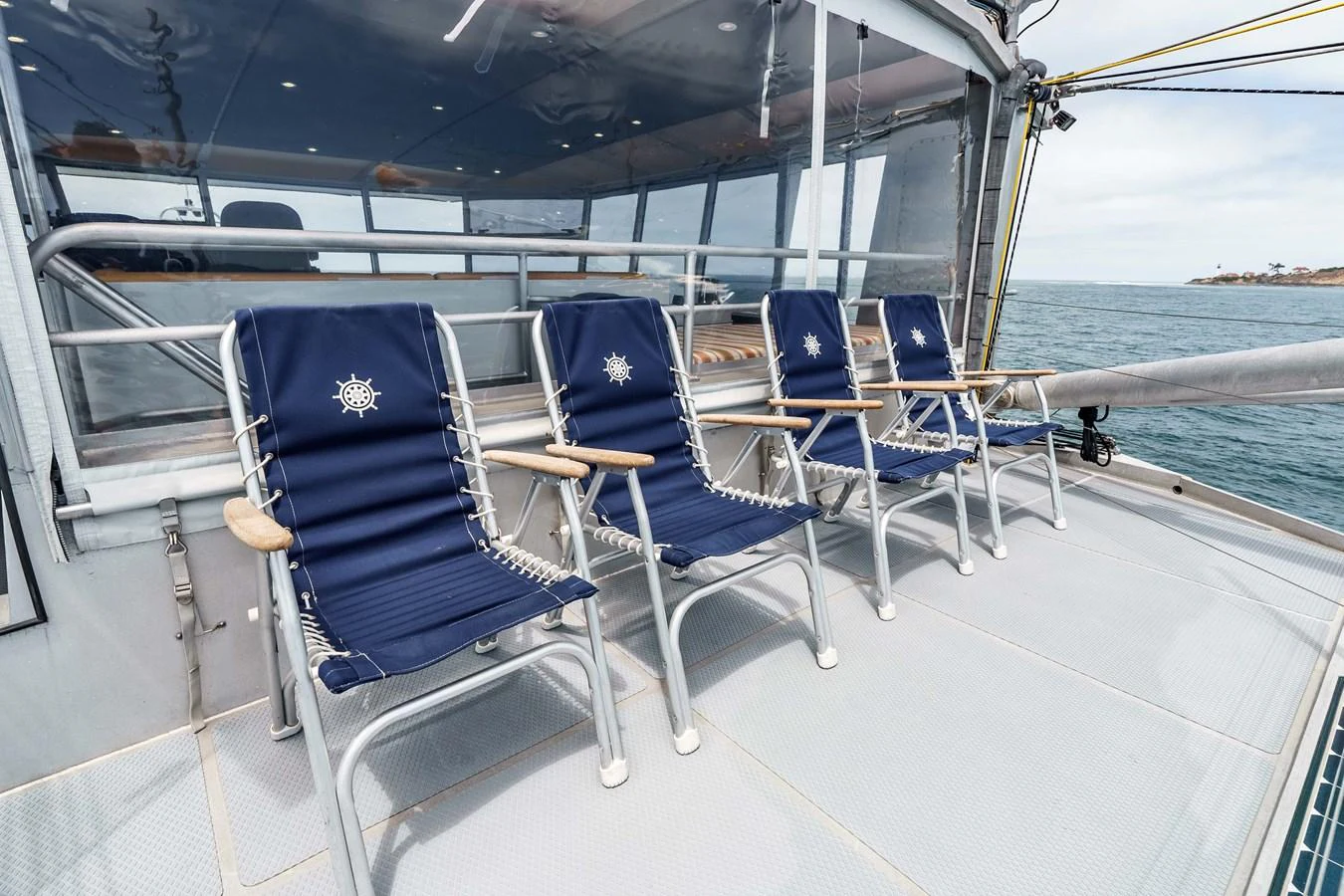 The sundeck features comfortable lounge chairs with a nautical theme, perfect for relaxation. aboard UGLY BETTY Yacht for Sale