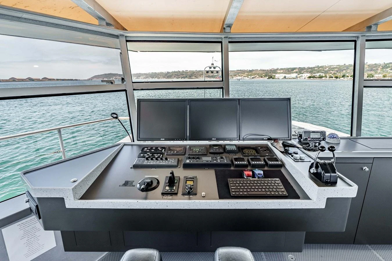 The helm station features state-of-the-art navigation and control systems with a panoramic view of the water. aboard UGLY BETTY Yacht for Sale
