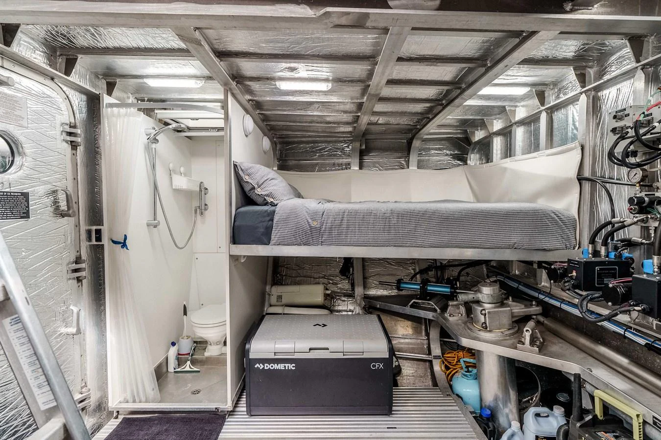 The crew quarters feature a compact bunk bed setup with essential amenities for comfort. aboard UGLY BETTY Yacht for Sale