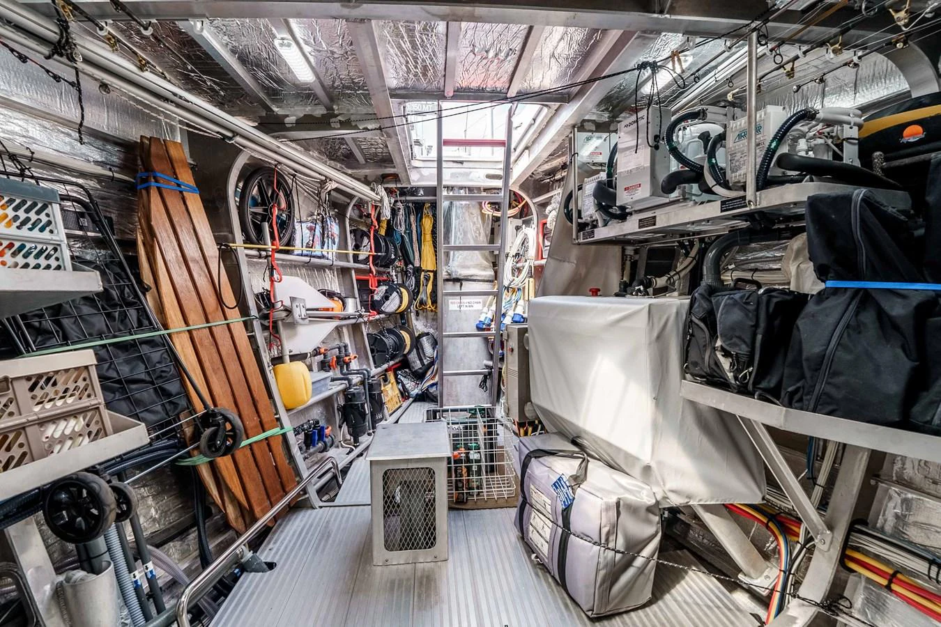 The yacht's engine room is well-organized with various equipment and tools neatly stored. aboard UGLY BETTY Yacht for Sale