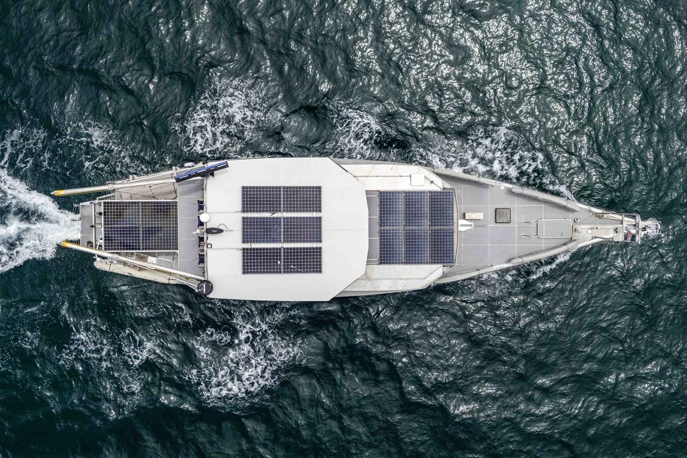 Aerial view of a sleek yacht with solar panels cruising through the water. aboard UGLY BETTY Yacht for Sale