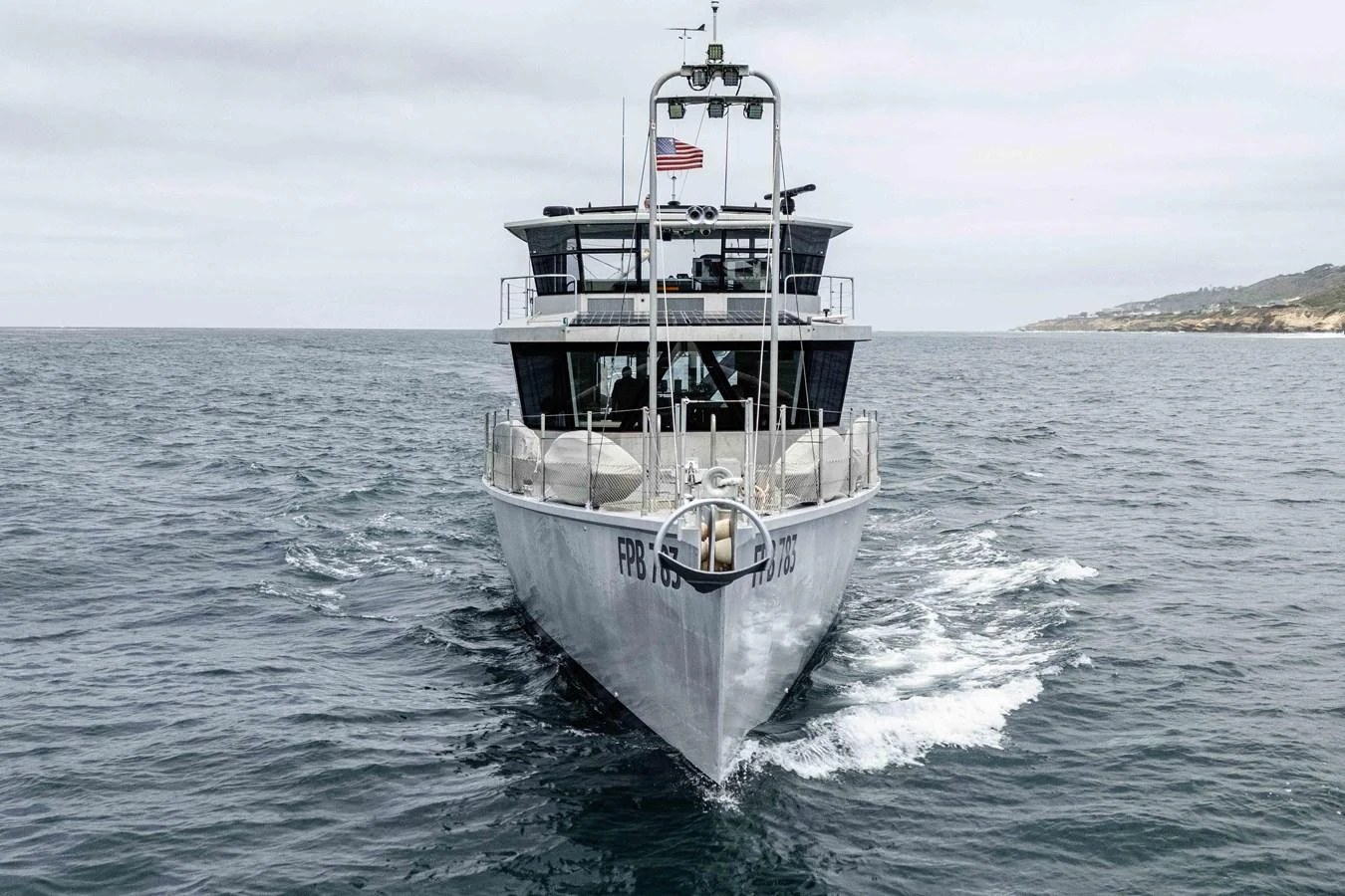 A sleek yacht cruises forward on open waters, showcasing its modern design and sturdy build. aboard UGLY BETTY Yacht for Sale