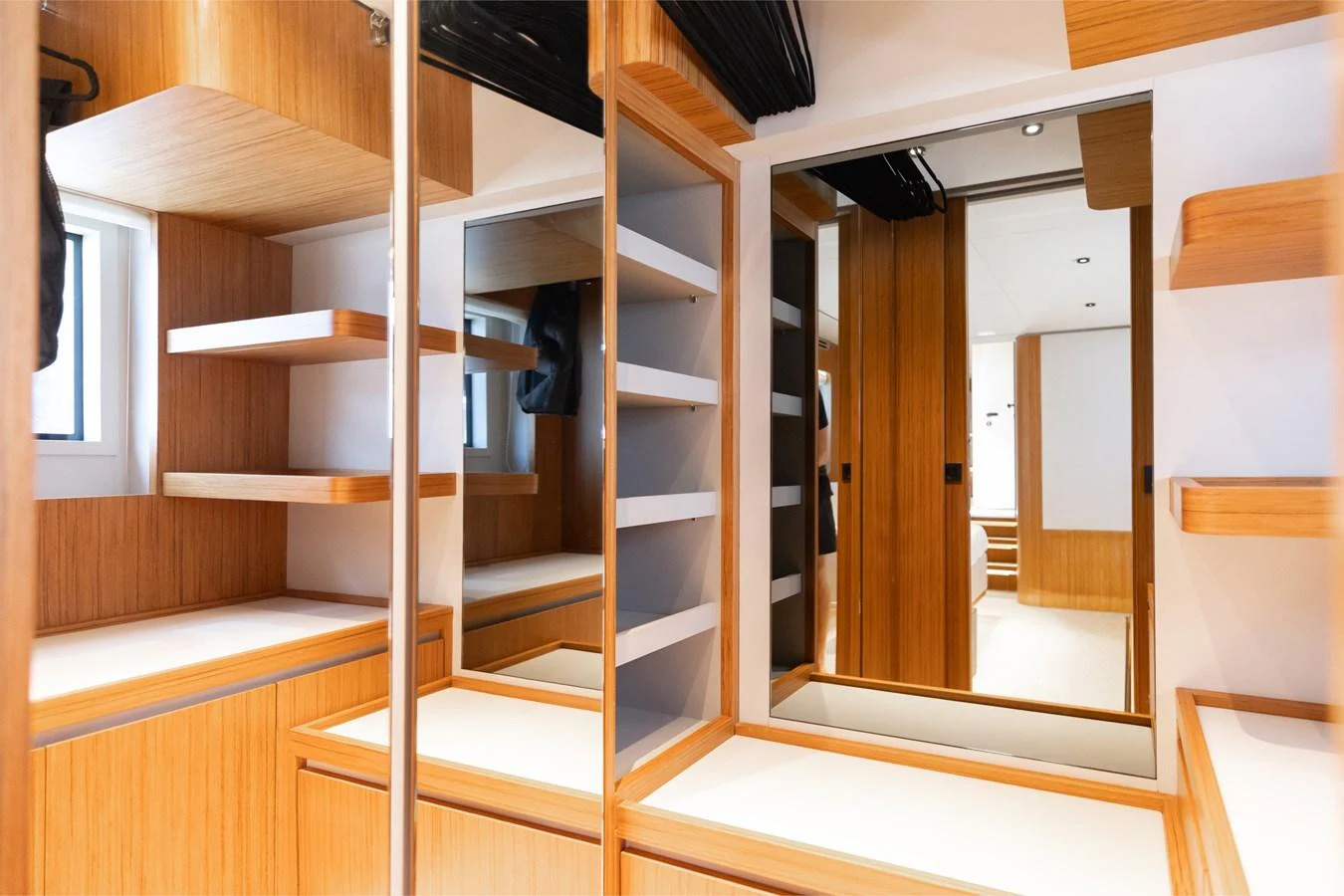 A well-organized yacht closet with ample shelving and mirrors. aboard KATRIN I Yacht for Sale
