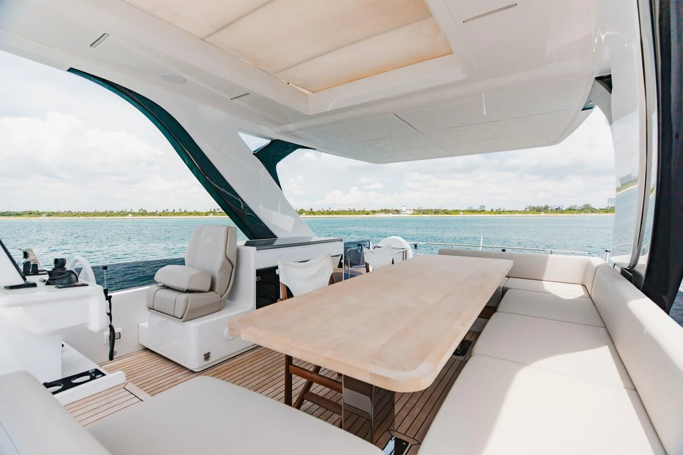 The aft deck features a spacious seating area with a large dining table, perfect for alfresco dining. aboard KATRIN I Yacht for Sale