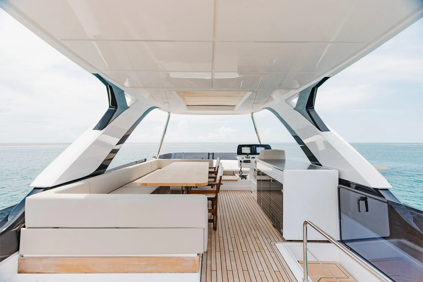The flybridge offers a spacious and elegant area for relaxation and dining with panoramic ocean views. aboard KATRIN I Yacht for Sale