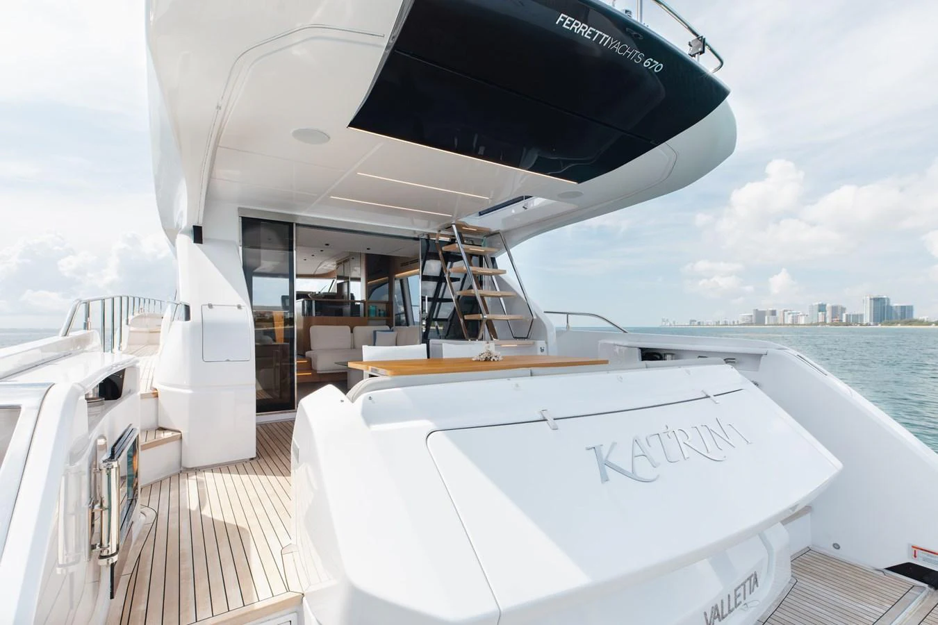 The yacht's aft deck features a spacious and inviting area with elegant design and direct access to the interior. aboard KATRIN I Yacht for Sale