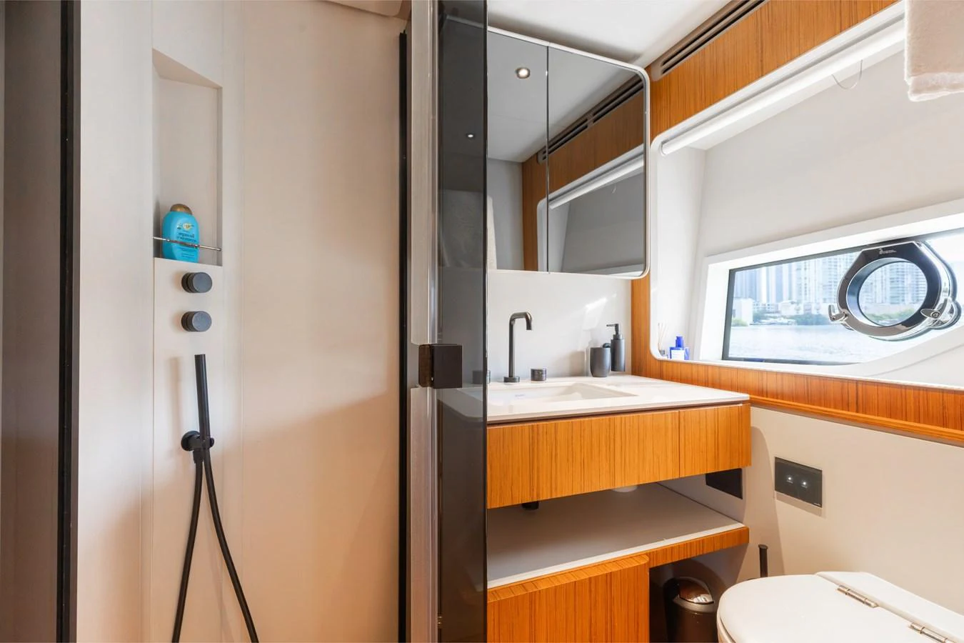 The yacht's bathroom features modern fixtures and a sleek design with a window providing natural light. aboard KATRIN I Yacht for Sale