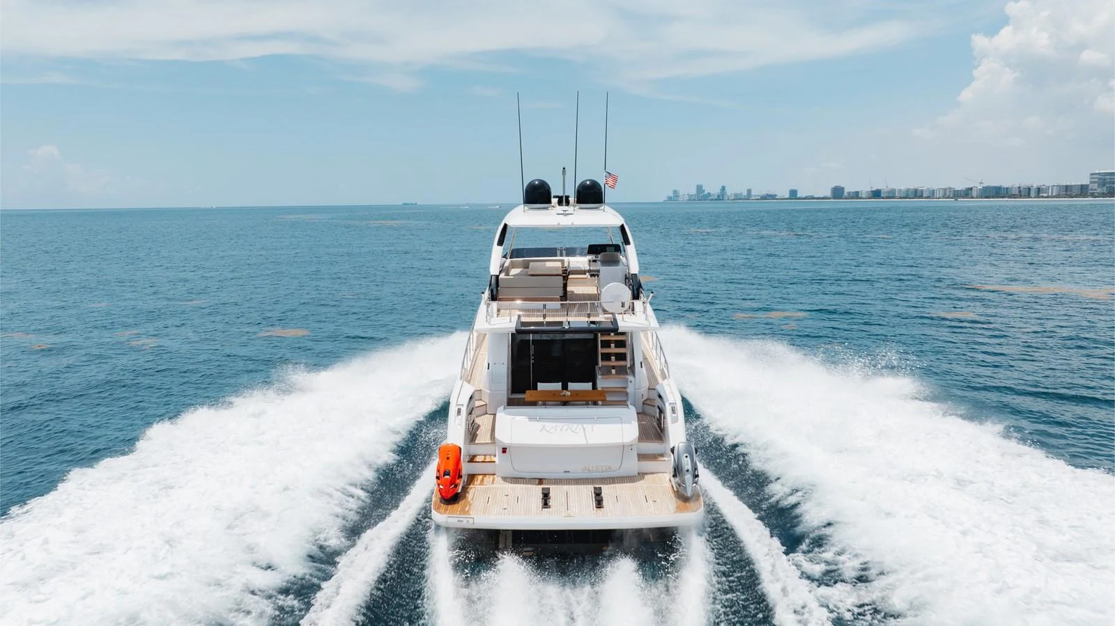 A sleek yacht cruises through open waters, leaving a trail of white wake behind. aboard KATRIN I Yacht for Sale