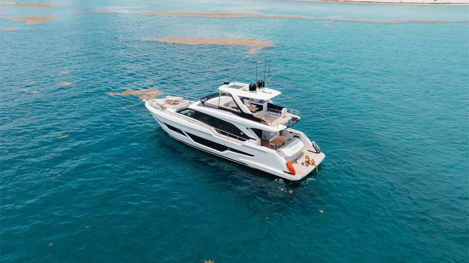 A sleek and modern yacht cruises through clear blue waters, showcasing its elegant design and spacious decks. aboard KATRIN I Yacht for Sale
