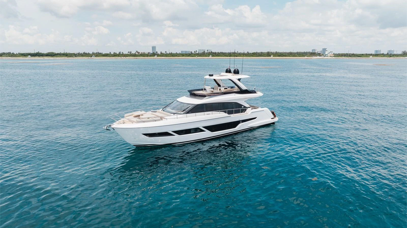 A sleek and modern yacht cruises gracefully on calm blue waters. aboard KATRIN I Yacht for Sale
