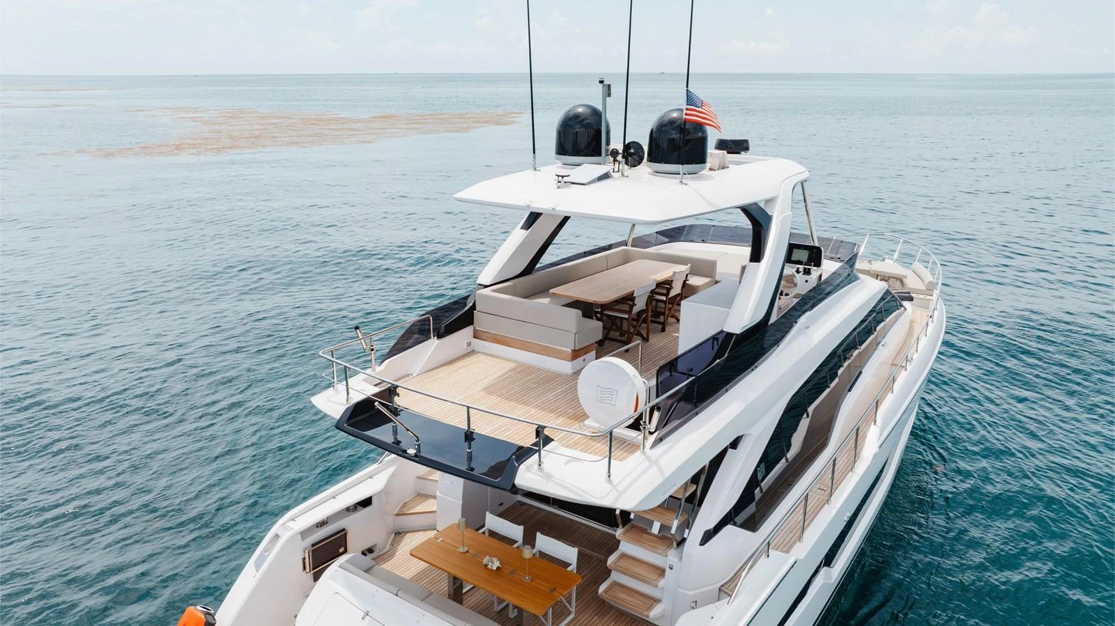 The yacht's aft deck offers a spacious and inviting area for relaxation and dining with stunning ocean views. aboard KATRIN I Yacht for Sale