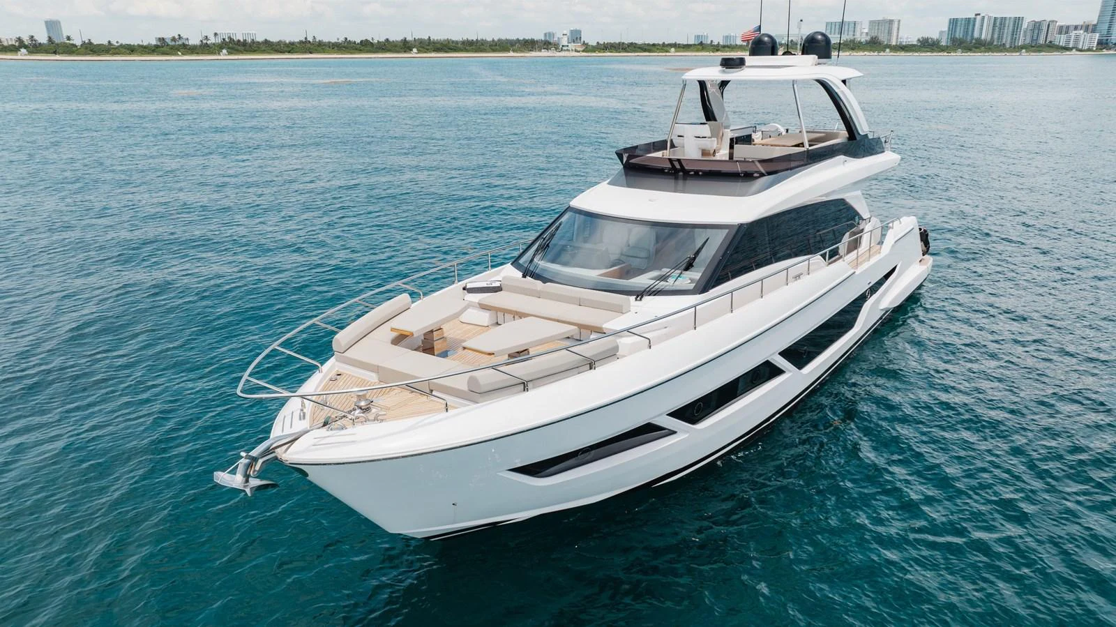 A sleek and modern yacht cruising on calm blue waters with a spacious flybridge and sunbathing area. aboard KATRIN I Yacht for Sale