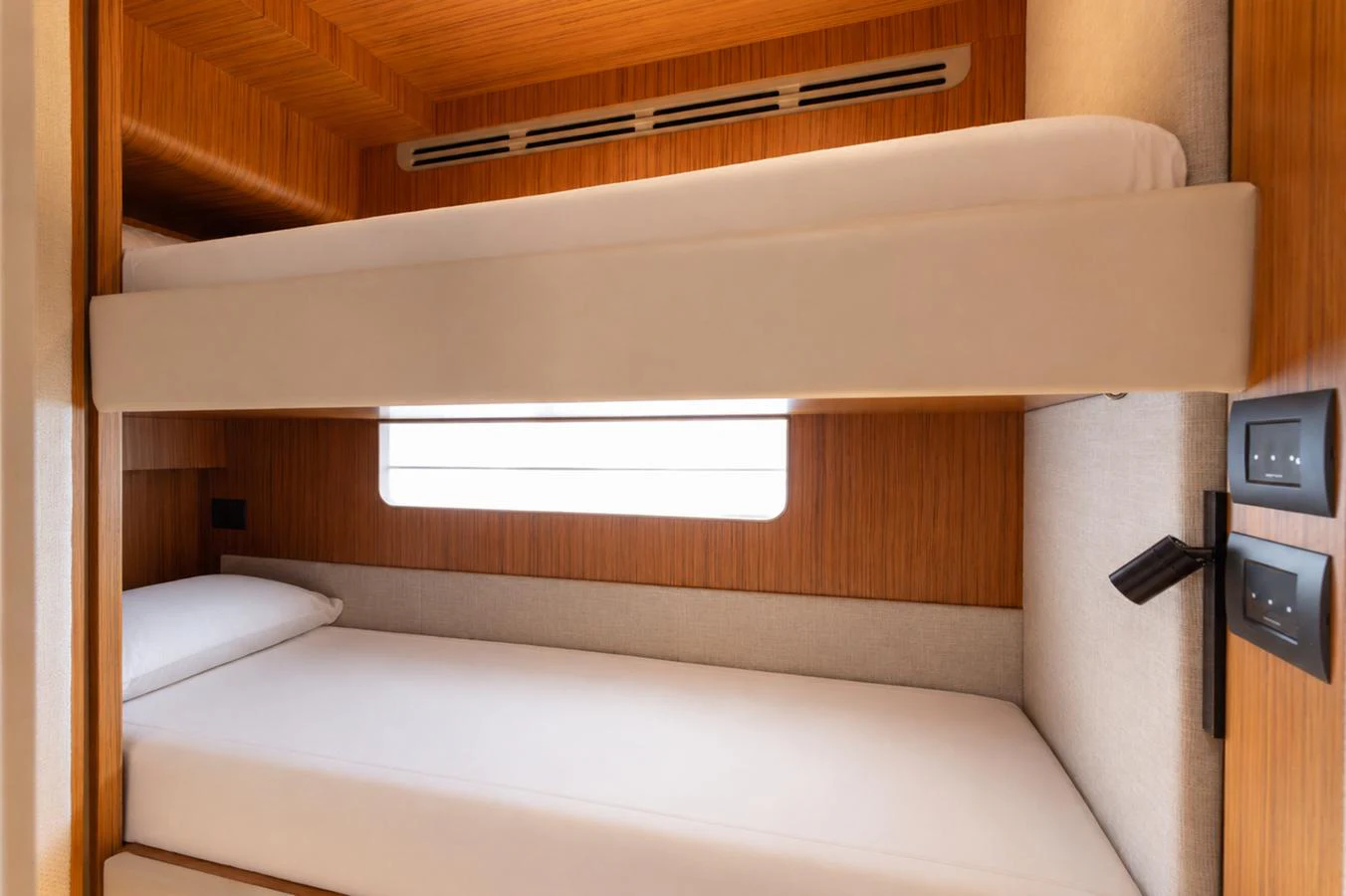The cozy bunk cabin features modern wood paneling and soft lighting. aboard KATRIN I Yacht for Sale