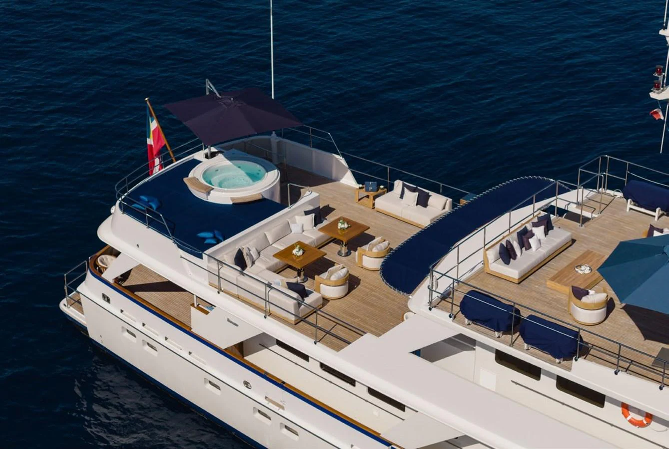 The yacht's sundeck features a luxurious hot tub, ample seating, and elegant dining areas, all set against the backdrop of the open sea. aboard PANACHE Yacht for Sale