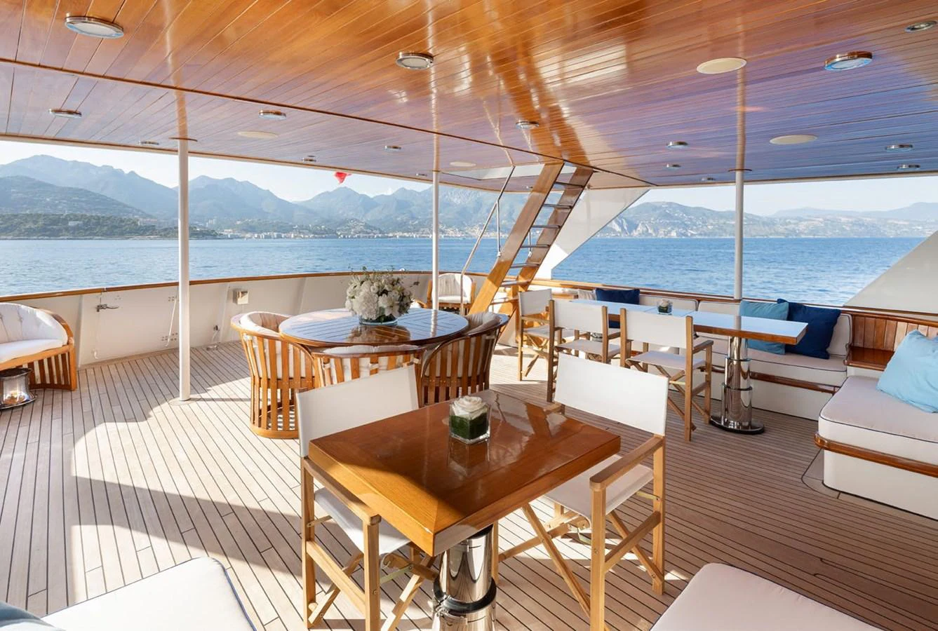 The aft deck offers a spacious and elegant outdoor dining and lounging area with stunning sea views. aboard PANACHE Yacht for Sale