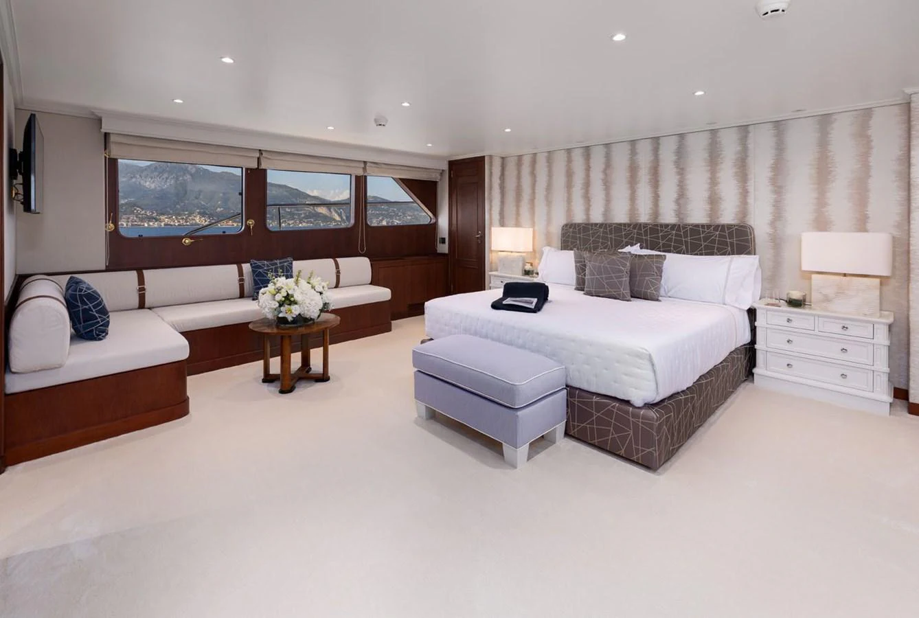 The master stateroom features a spacious layout with a large bed, comfortable seating, and elegant decor. aboard PANACHE Yacht for Sale