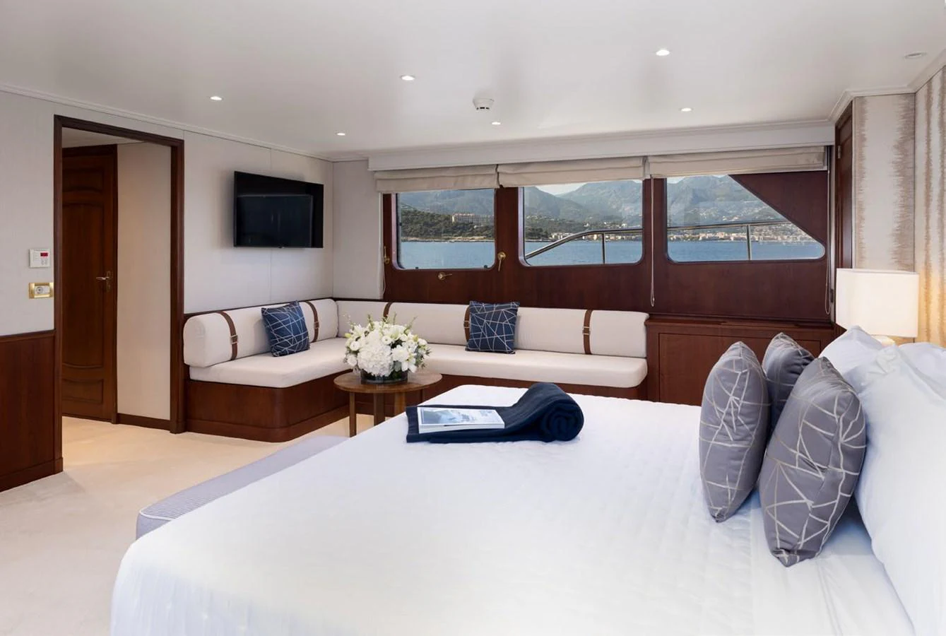 The master stateroom features a spacious layout with elegant decor and large windows offering scenic views. aboard PANACHE Yacht for Sale
