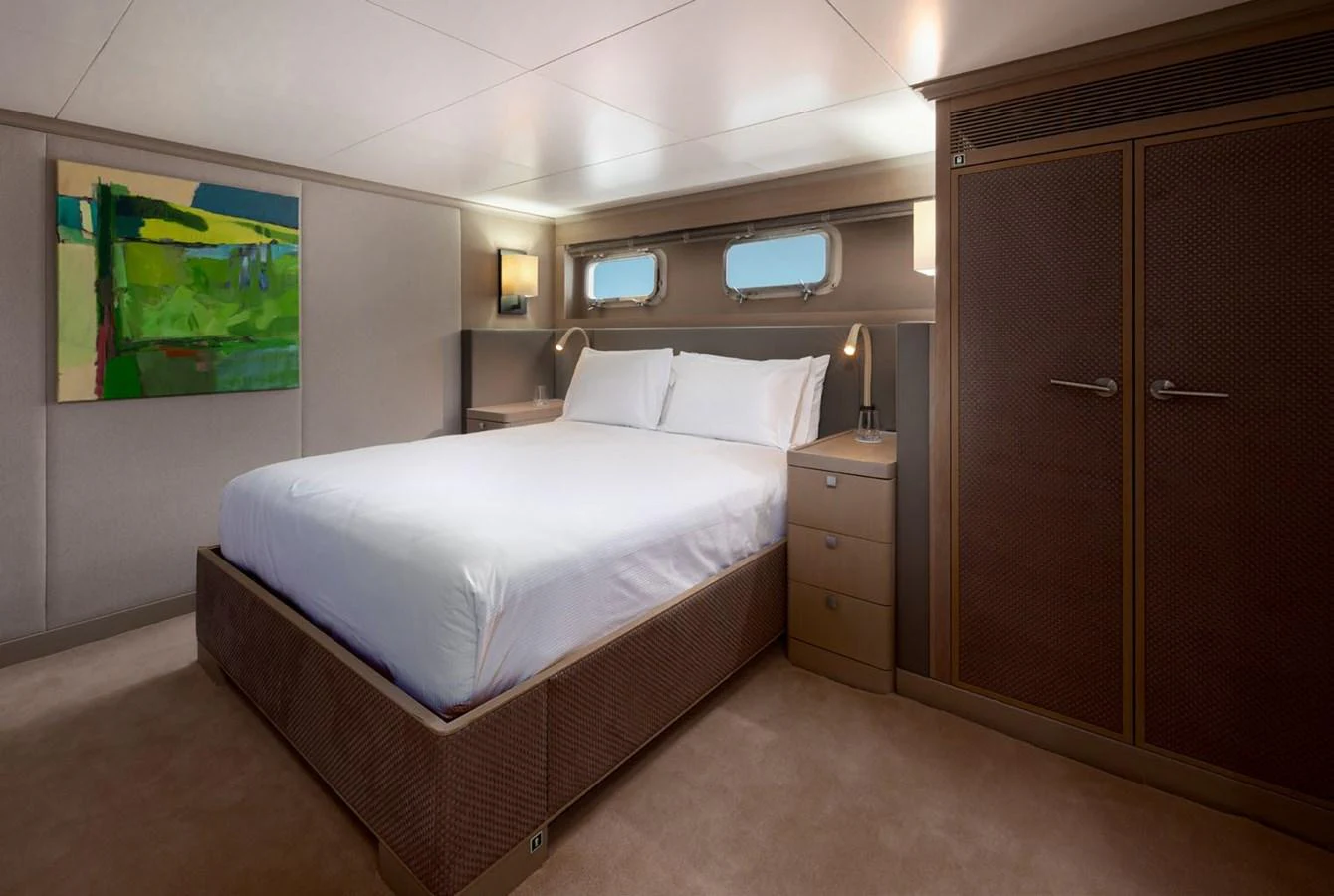 A luxurious stateroom featuring a comfortable bed and elegant furnishings. aboard PANACHE Yacht for Sale
