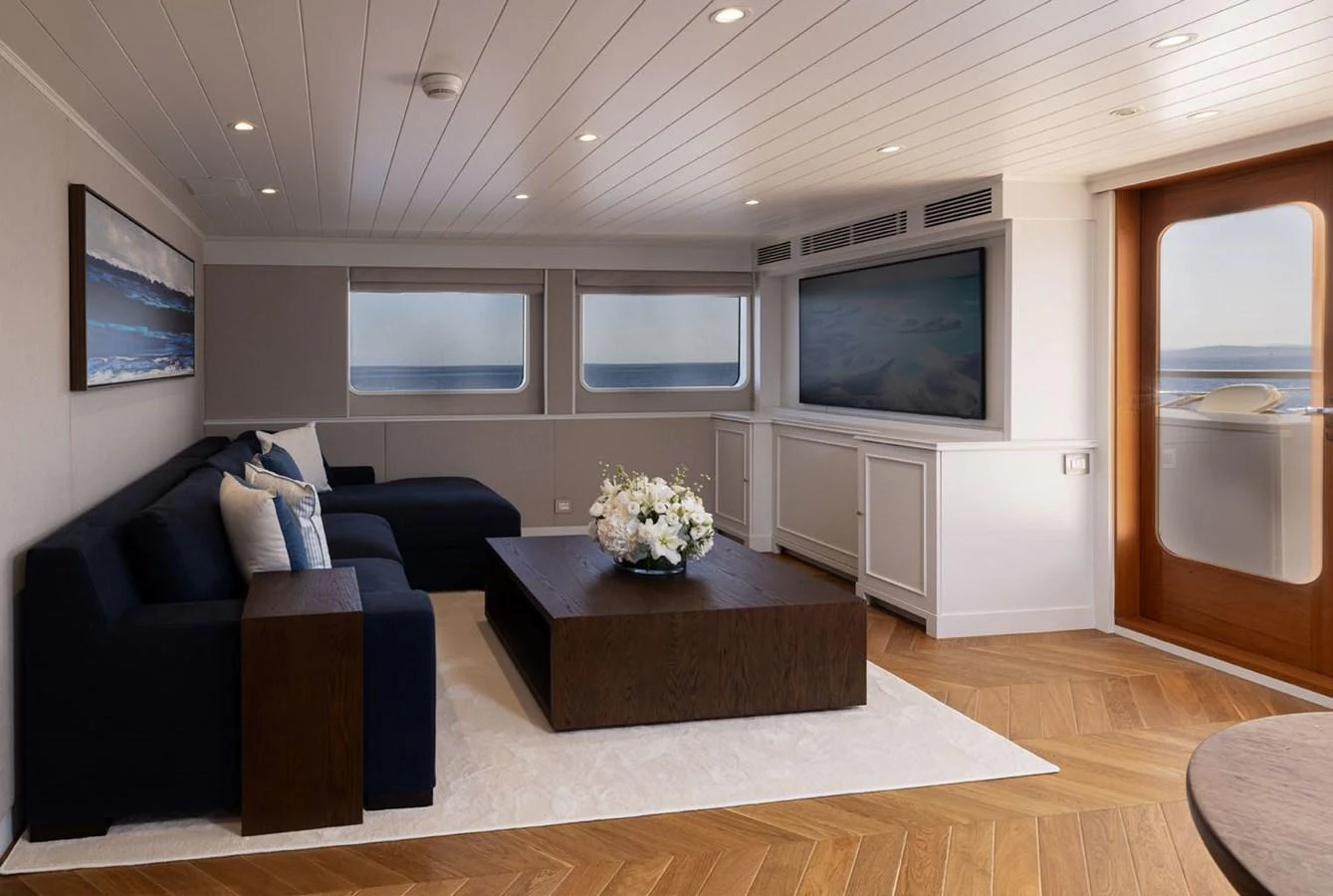 The salon features a cozy seating area with a large TV and elegant decor. aboard PANACHE Yacht for Sale