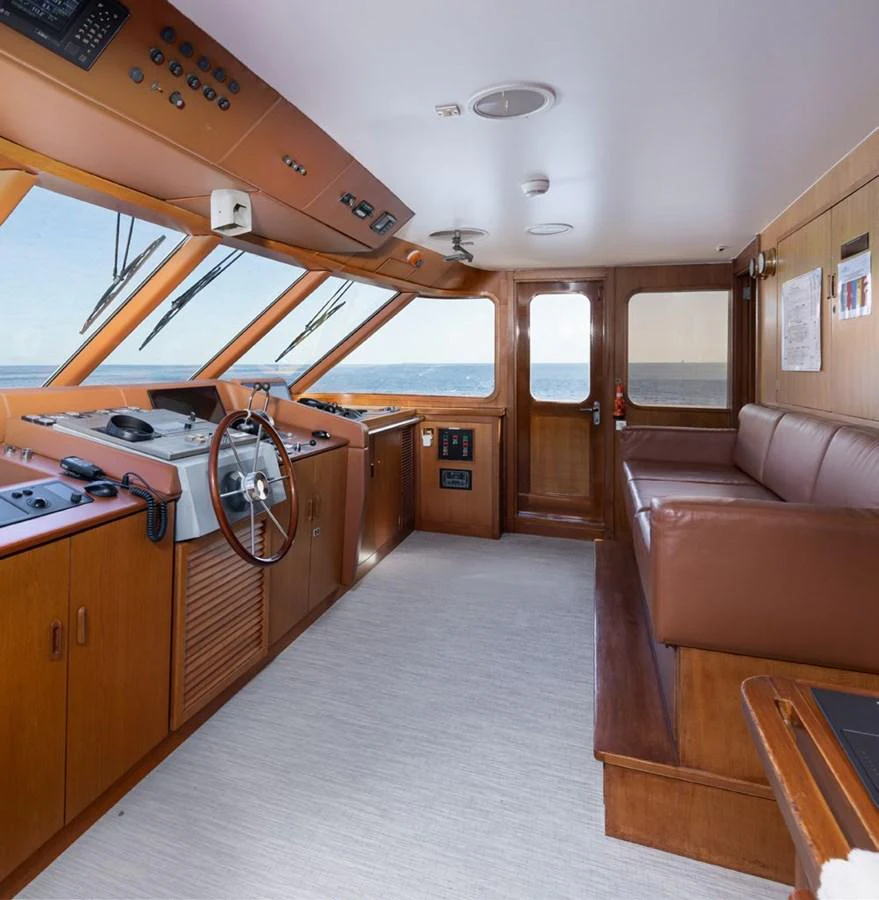 The helm station features a comfortable seating area and a well-equipped control panel with panoramic views. aboard PANACHE Yacht for Sale