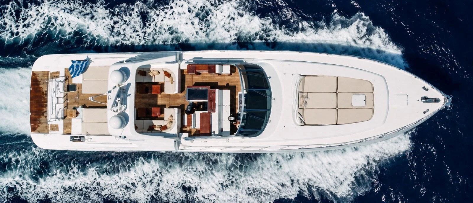 A stunning aerial view of a luxurious yacht cruising through the water. aboard ANGELINA Yacht for Sale