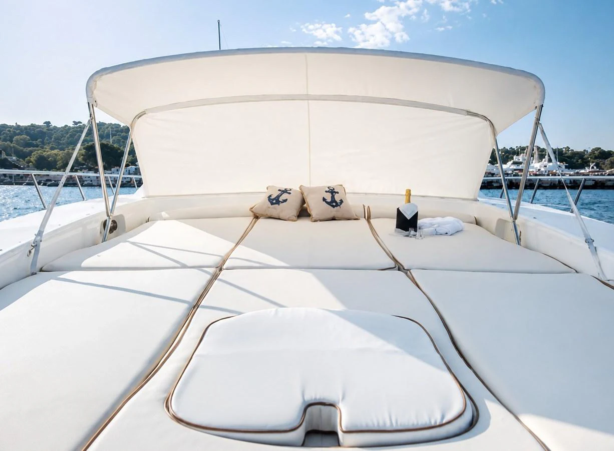 The sundeck offers a luxurious lounging area with plush cushions and a sunshade, perfect for relaxation. aboard ANGELINA Yacht for Sale