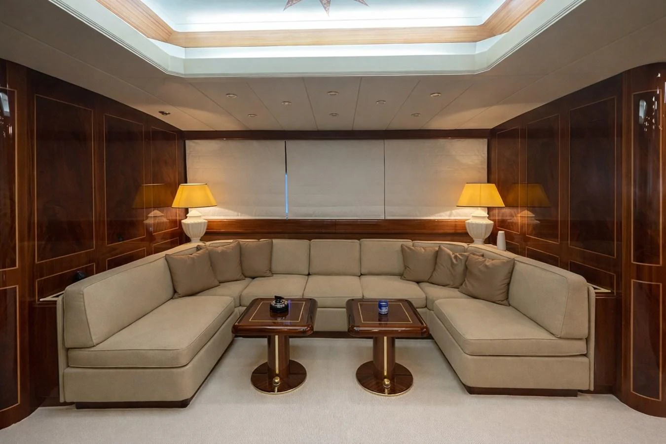 The salon features a luxurious seating area with plush sofas and elegant wooden accents. aboard ANGELINA Yacht for Sale