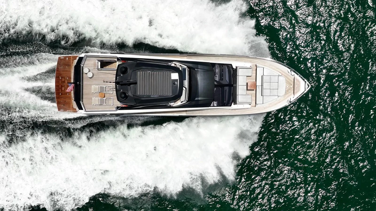 An aerial view of a sleek yacht cruising through the water, showcasing its elegant design and powerful performance. aboard HOTEL COLLECTION Yacht for Sale