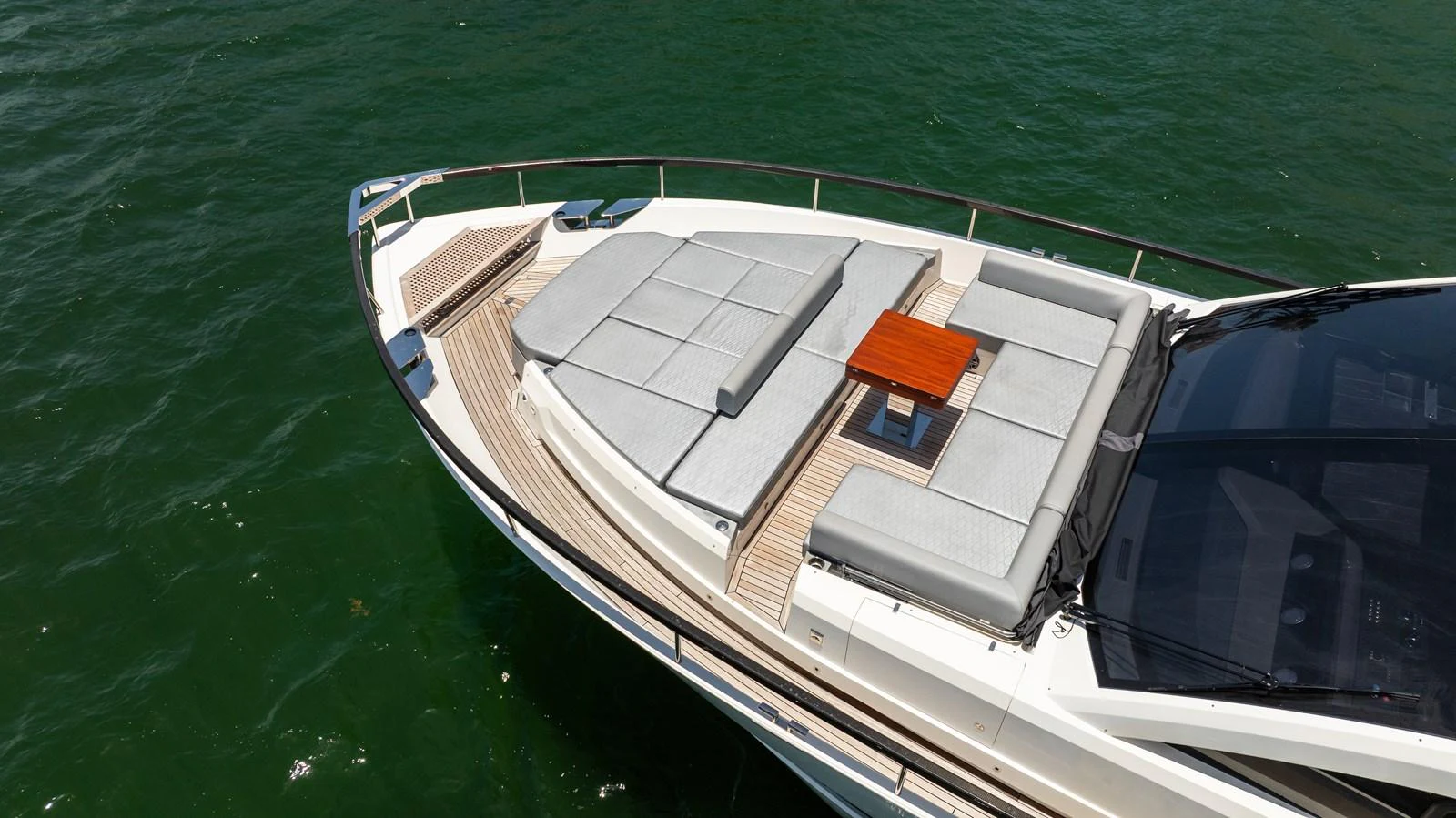 The yacht's foredeck features spacious sun pads and a small table, perfect for relaxation. aboard HOTEL COLLECTION Yacht for Sale